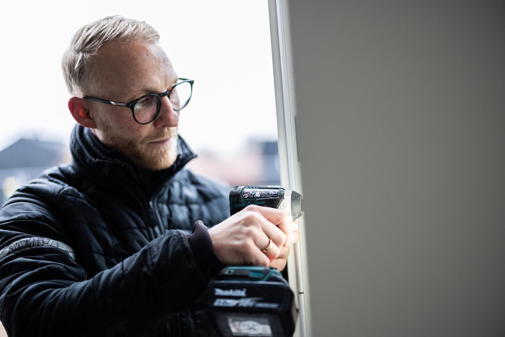 Jesper måler op til nyt trægulv med boremaskine